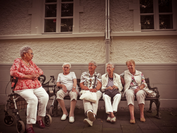 elderly people sitting on a bench